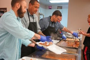 Men serving meals