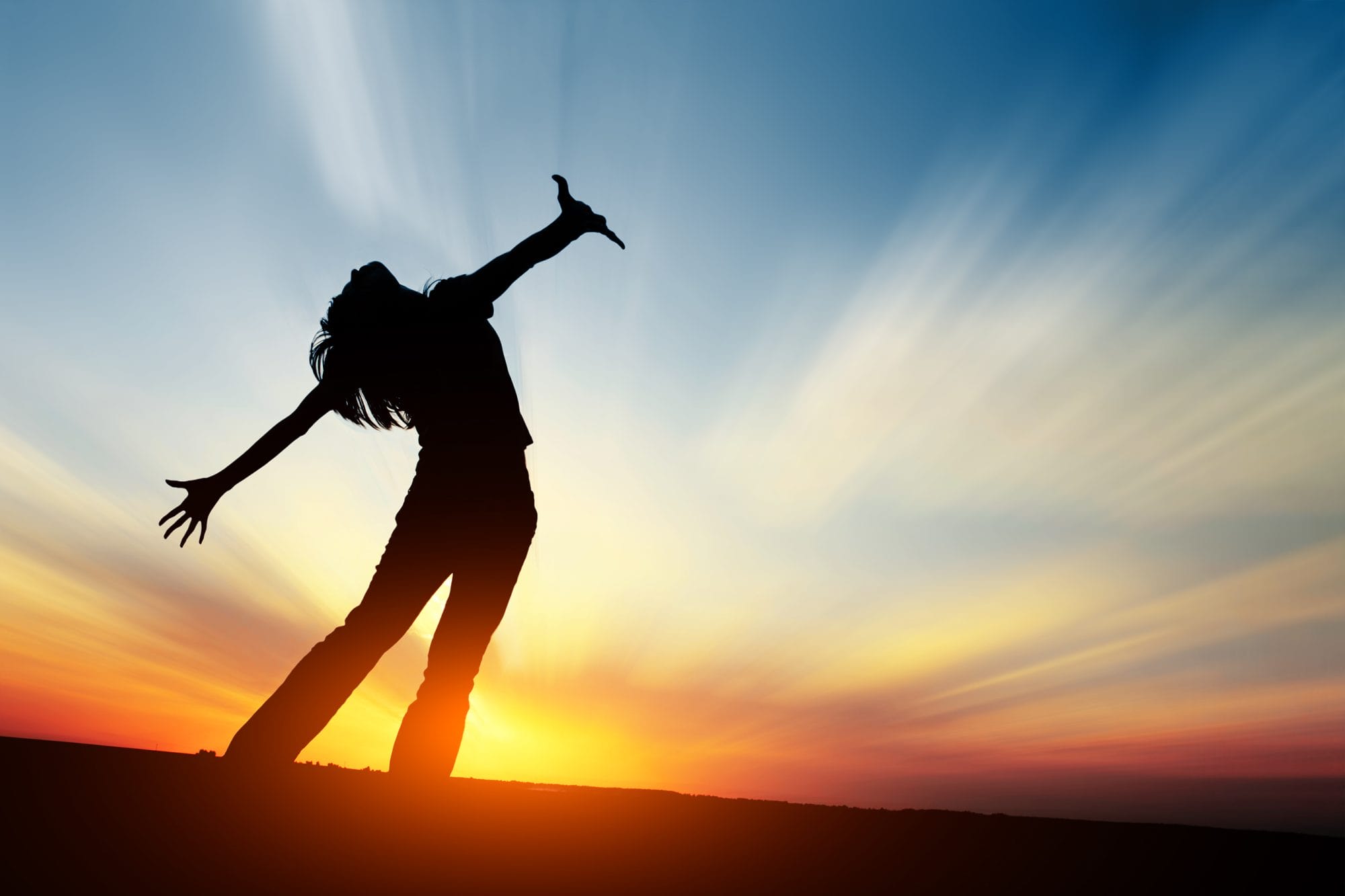 Silhouette of young woman with sunset