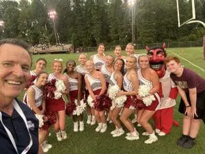 Sheldon Haygood on sideline with cheerleaders
