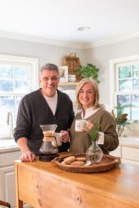 Anna and Tyler in kitchen holding coffee cups