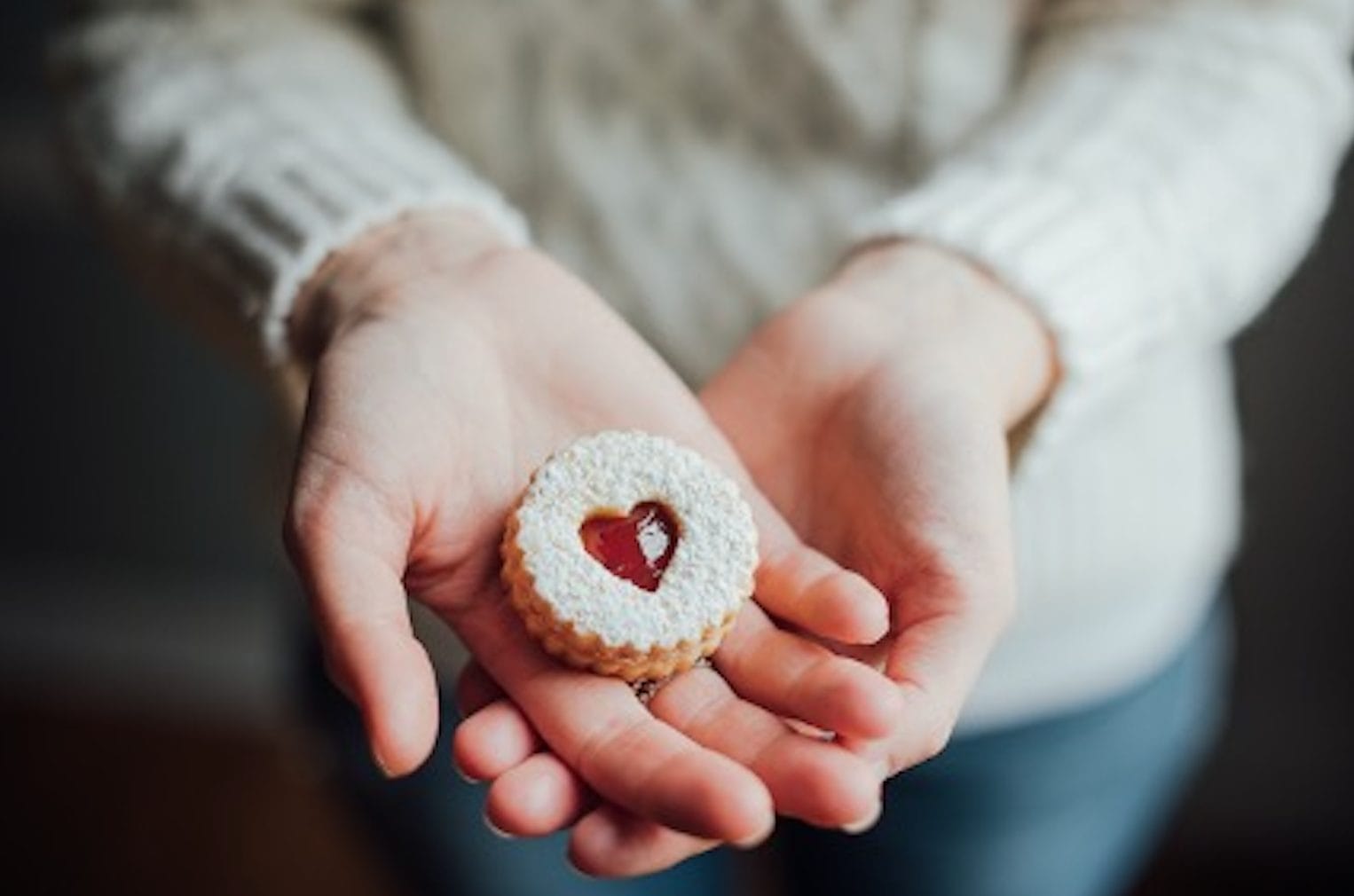 Woman holding heart cookie