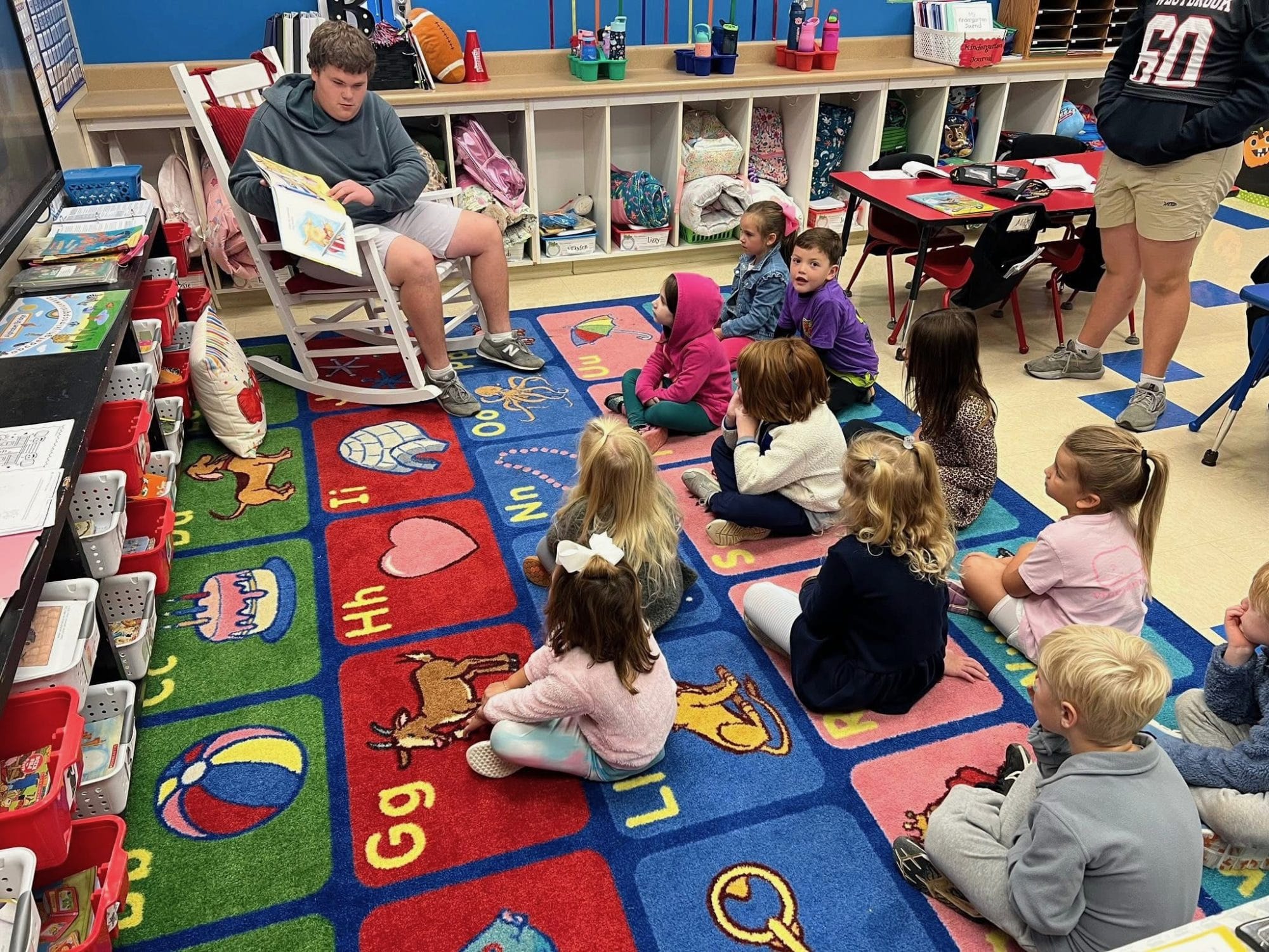 Boy reading to little children