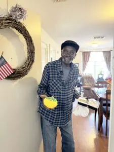 Meals on Wheels recipient holding pumpkin