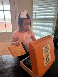 Little girl opening Little Creator Box