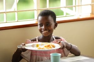 Sozo child holding plate