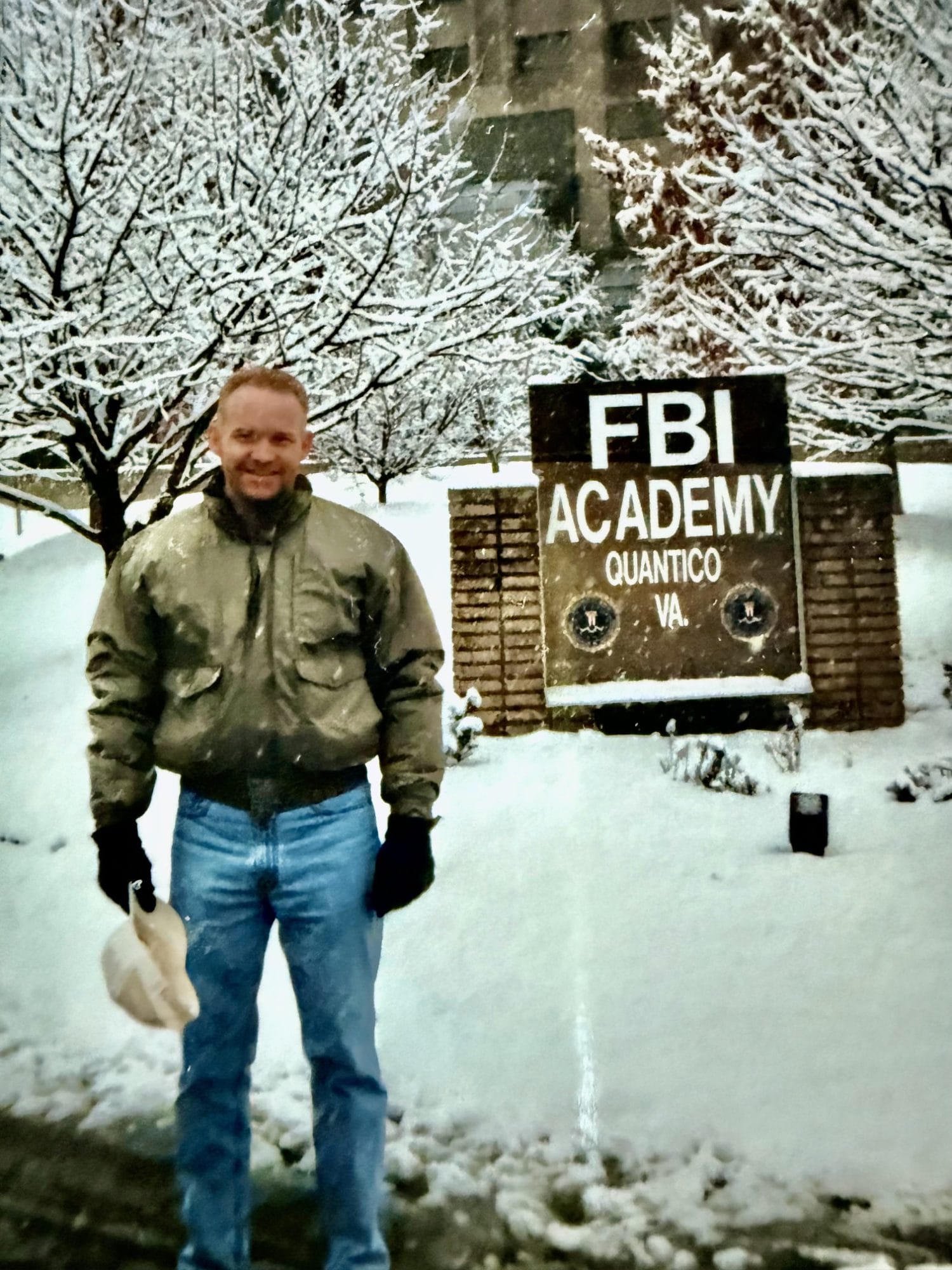 David Standridge in front of Quantico sign