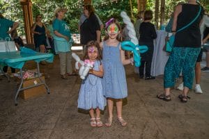 Together in Teal girls with faces painted and balloons