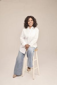 CeCe in white shirt beige background photo credit Hannah Burton