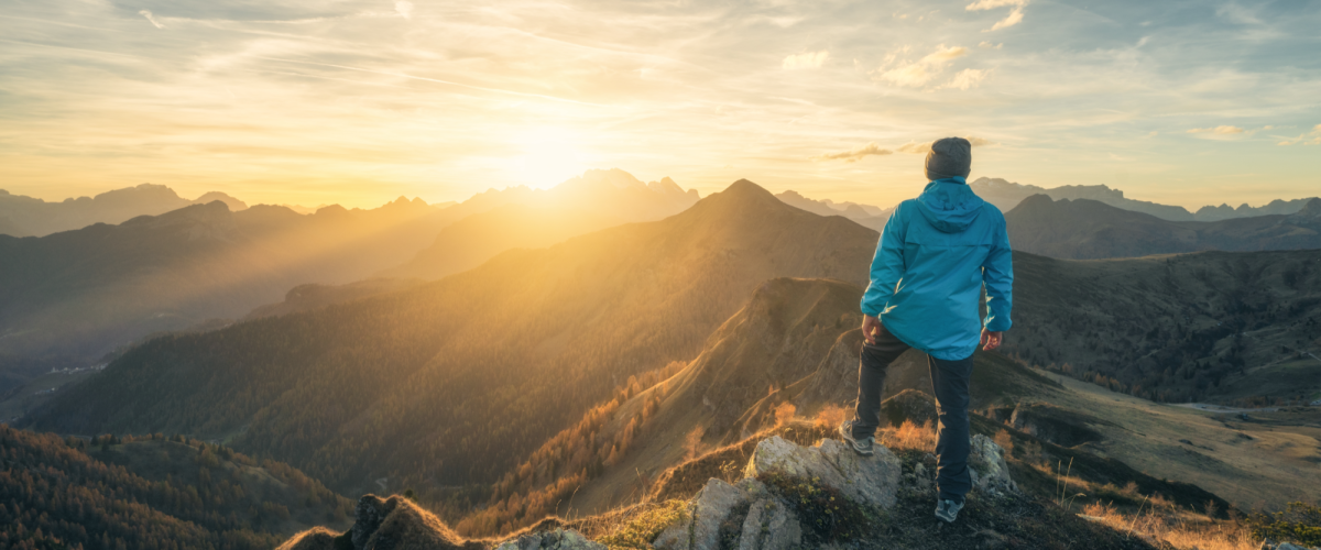 Man on top of mountain with sunrise Man on top of mountain with sunrise